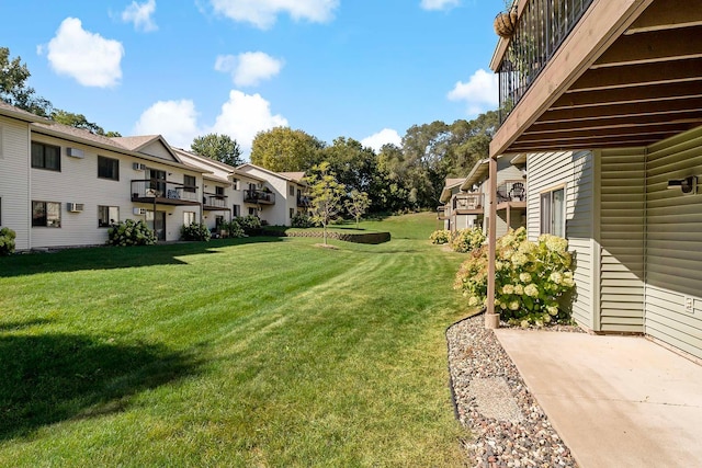 view of yard with a balcony