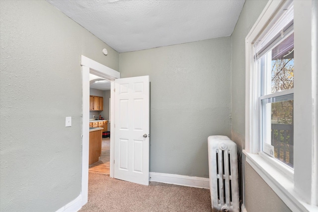 interior space featuring radiator and a textured ceiling