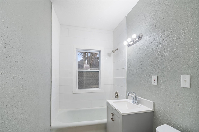 full bathroom featuring vanity, toilet, and tiled shower / bath