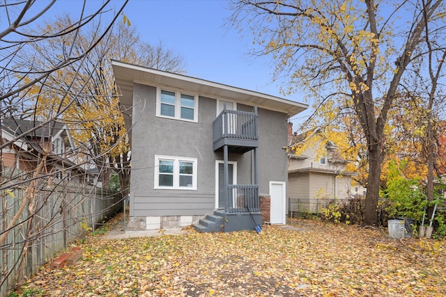 rear view of property featuring a balcony