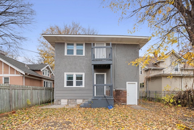 back of property featuring a balcony