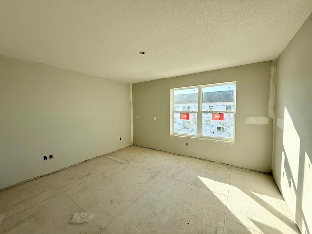 empty room featuring a textured ceiling