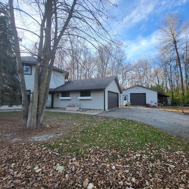 view of front facade featuring a garage and an outdoor structure