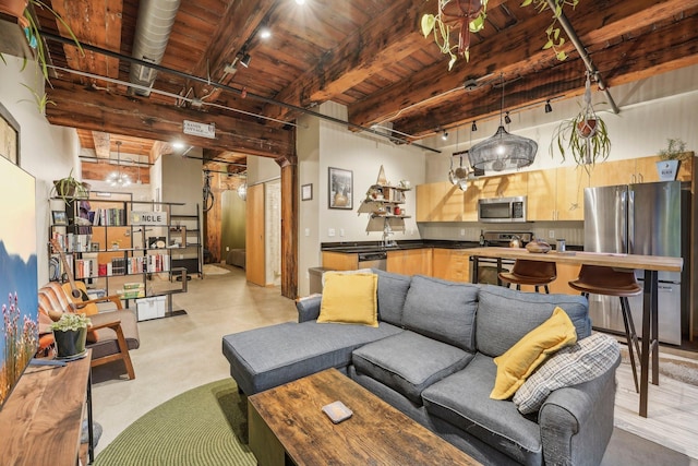 living room with beamed ceiling, wood ceiling, and sink