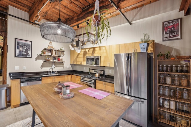 kitchen with pendant lighting, wooden ceiling, sink, beamed ceiling, and stainless steel appliances