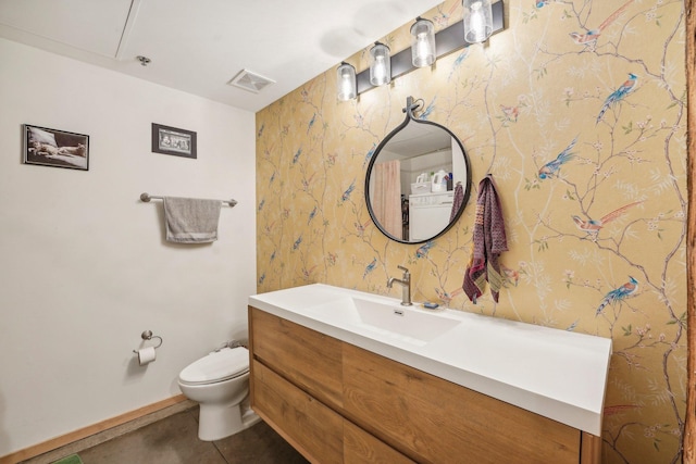 bathroom featuring tile patterned floors, vanity, and toilet