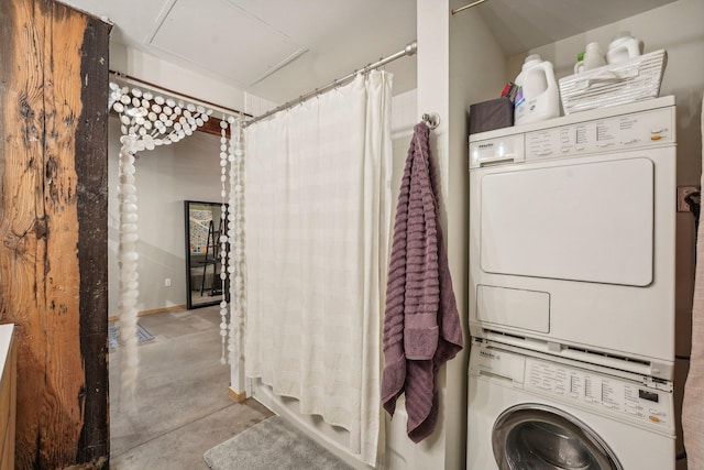 laundry room featuring stacked washer / drying machine