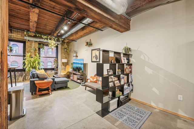 interior space featuring wooden ceiling, beamed ceiling, and concrete floors