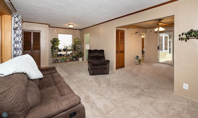 living room with light colored carpet, ceiling fan, and crown molding