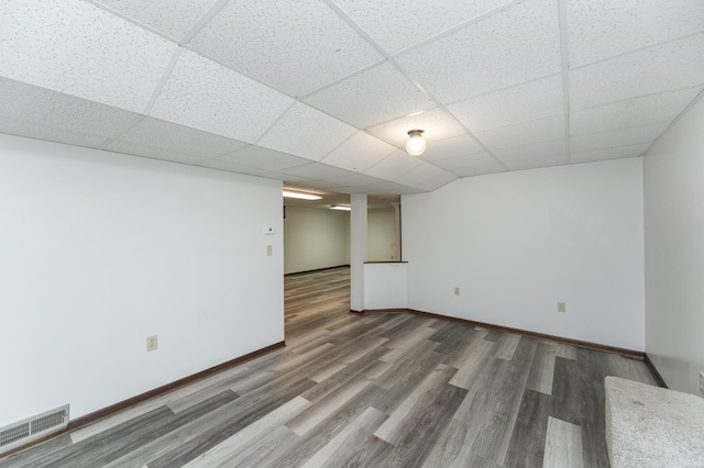 basement featuring hardwood / wood-style floors and a drop ceiling