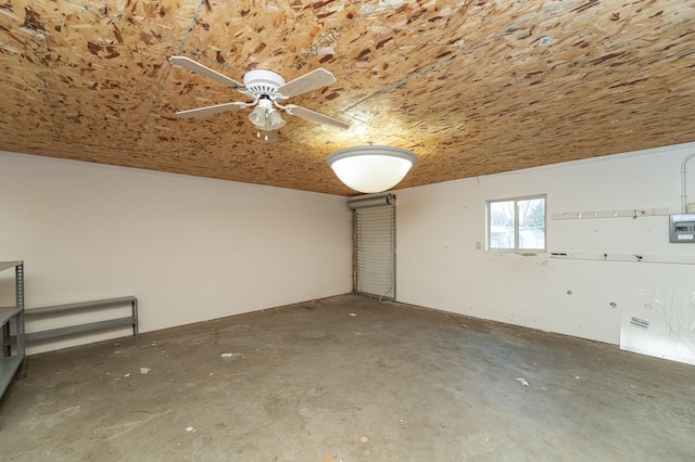 spare room with ceiling fan and concrete floors