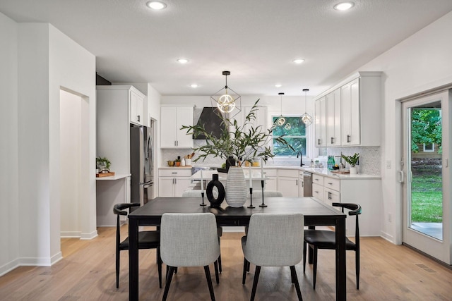 dining area featuring a chandelier and light hardwood / wood-style floors