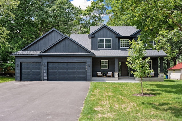 craftsman house featuring a garage, a front yard, and a porch