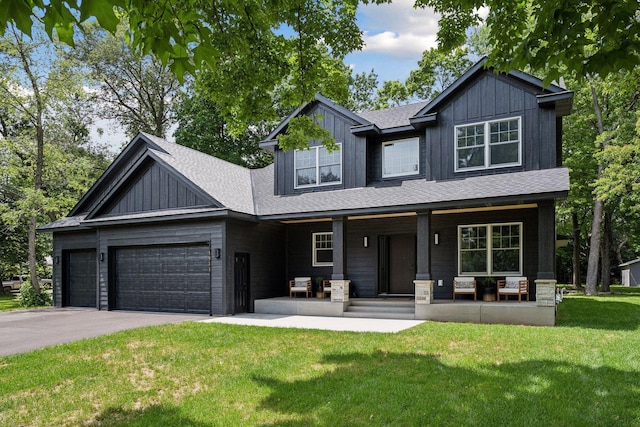 craftsman house with a front lawn, a garage, and covered porch