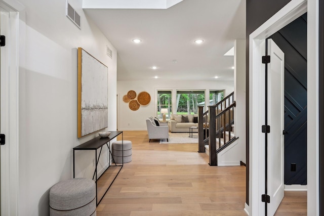 hallway with light hardwood / wood-style flooring