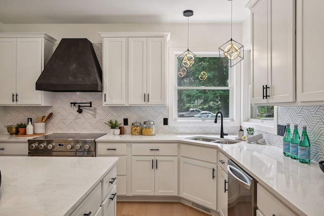 kitchen featuring white cabinets, custom range hood, sink, and appliances with stainless steel finishes