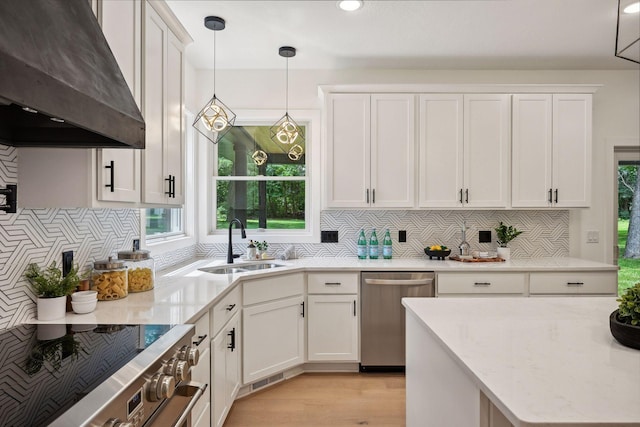 kitchen with light hardwood / wood-style flooring, sink, exhaust hood, white cabinetry, and appliances with stainless steel finishes