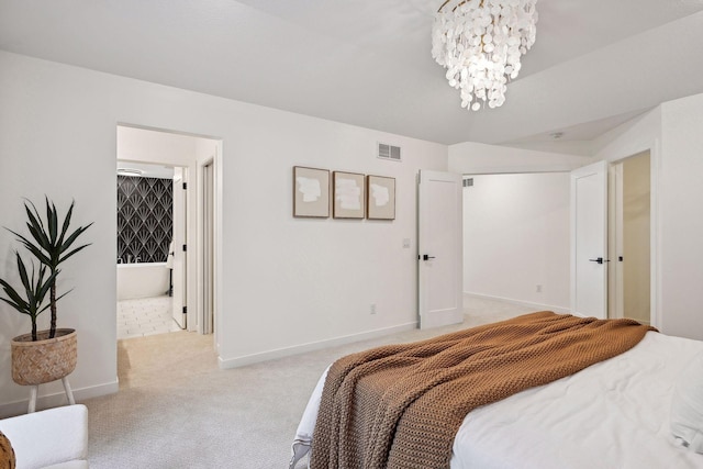 bedroom featuring a chandelier, connected bathroom, and light carpet