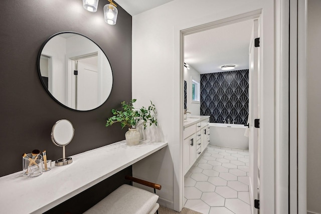 bathroom with tile patterned flooring, a bathtub, and vanity