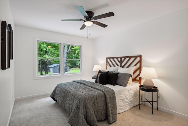 bedroom featuring ceiling fan and light carpet