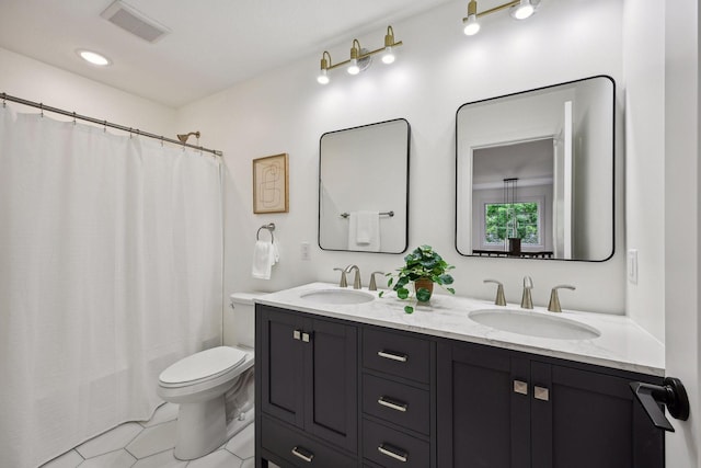 bathroom featuring tile patterned flooring, vanity, and toilet