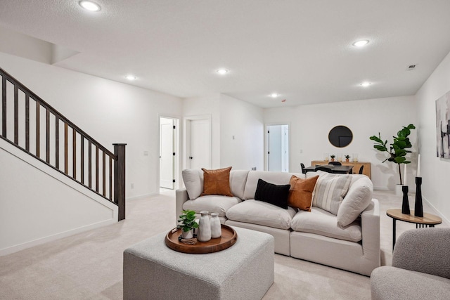 carpeted living room featuring a textured ceiling