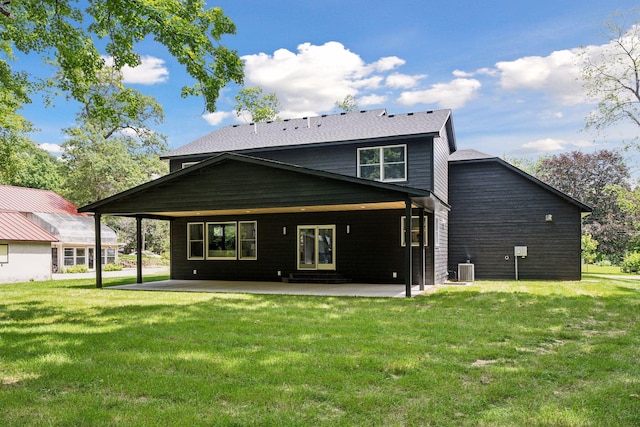 back of property with central air condition unit, a lawn, and a patio area