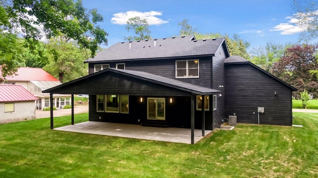 rear view of property featuring a yard and a patio area