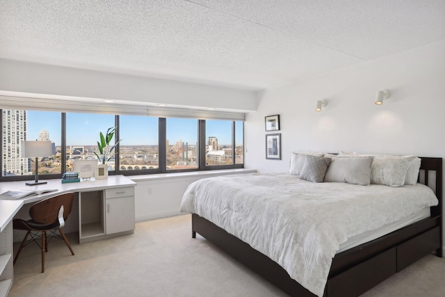 carpeted bedroom featuring a textured ceiling and multiple windows