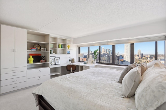 carpeted bedroom featuring a textured ceiling