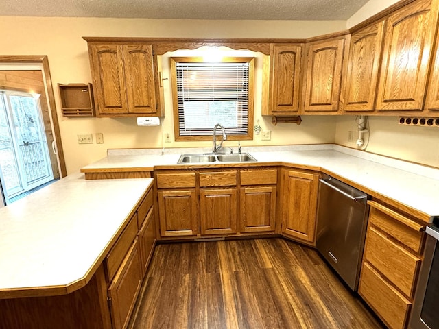 kitchen with a wealth of natural light, sink, dark wood-type flooring, and appliances with stainless steel finishes