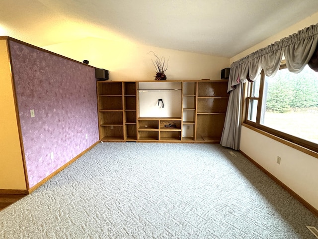 unfurnished living room featuring carpet floors and lofted ceiling