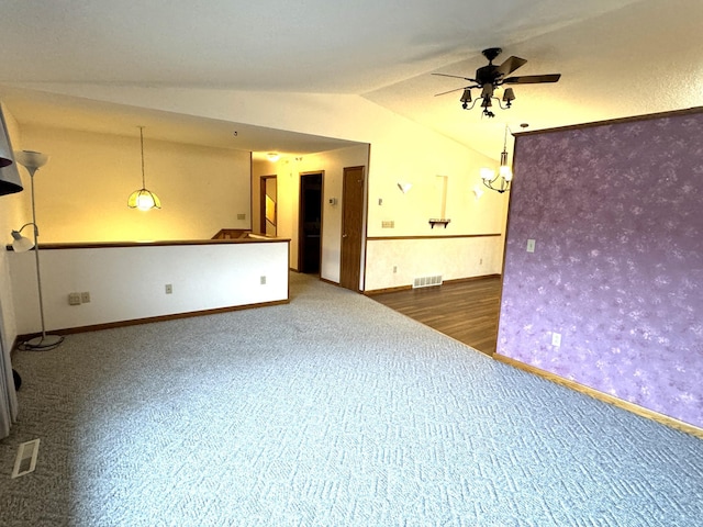 unfurnished room featuring ceiling fan, dark wood-type flooring, and vaulted ceiling