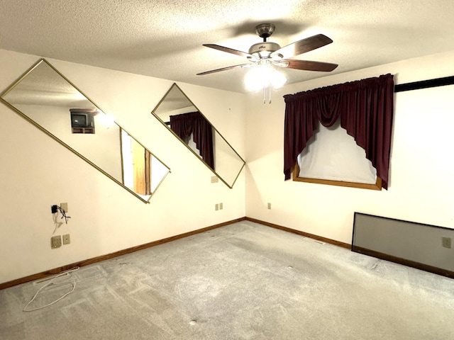 bonus room featuring light carpet, a textured ceiling, and ceiling fan