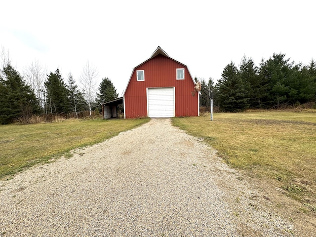 view of outbuilding featuring a yard and a garage