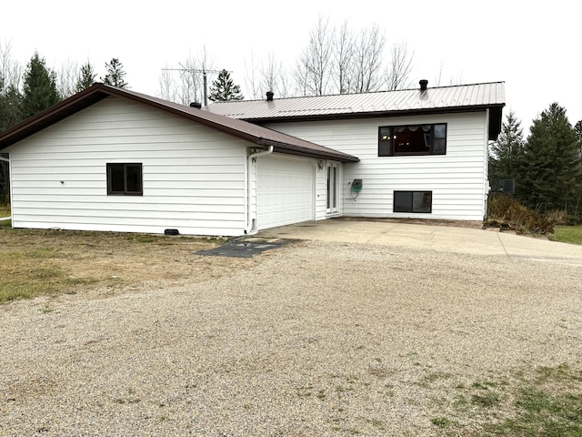 rear view of property featuring a garage