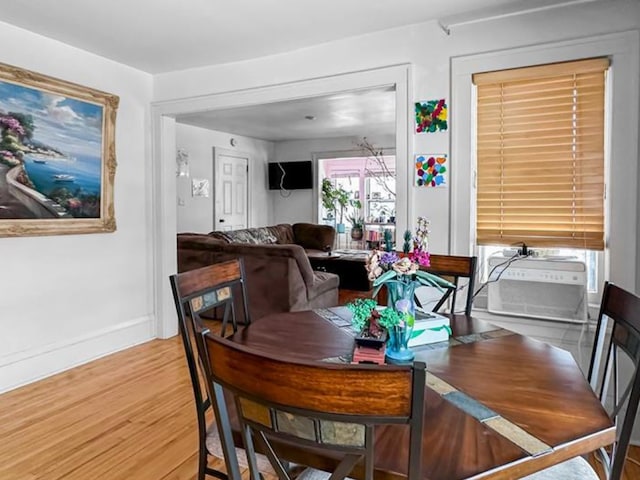 dining room featuring baseboards and wood finished floors