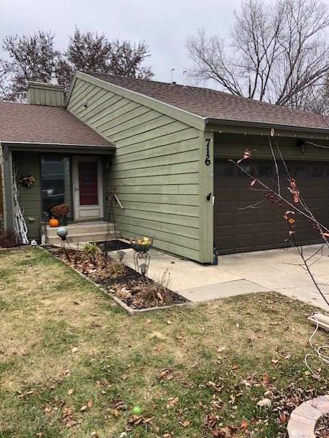 exterior space featuring a front lawn and a garage