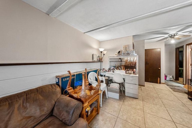 living room featuring ceiling fan, light tile patterned flooring, and built in desk