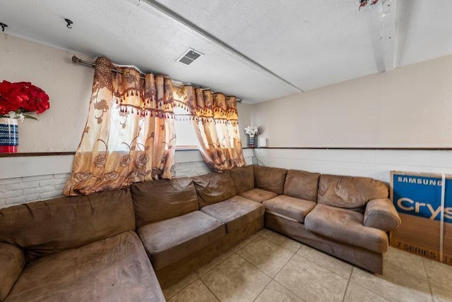 tiled living room with a textured ceiling