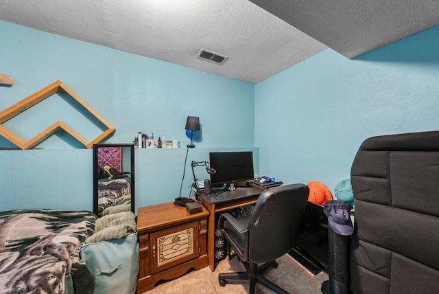 carpeted office featuring a textured ceiling