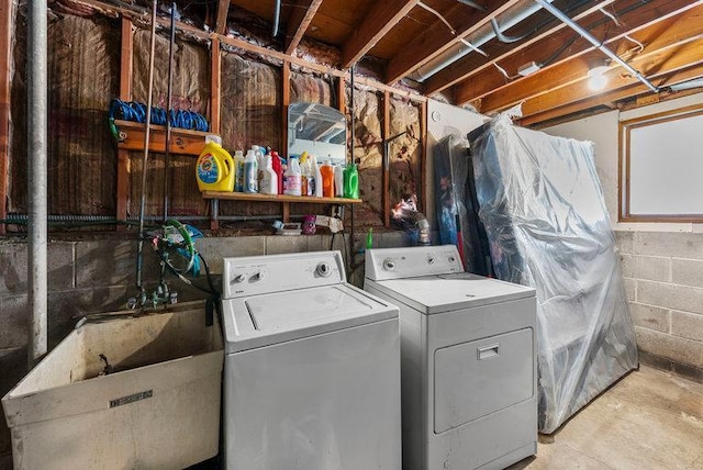 laundry room featuring washing machine and clothes dryer and sink