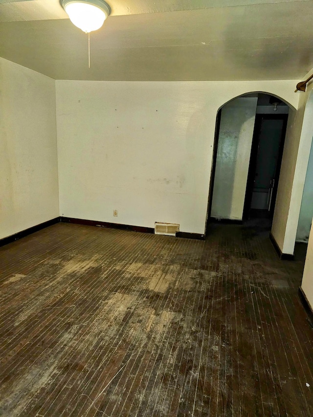 unfurnished room with dark hardwood / wood-style flooring