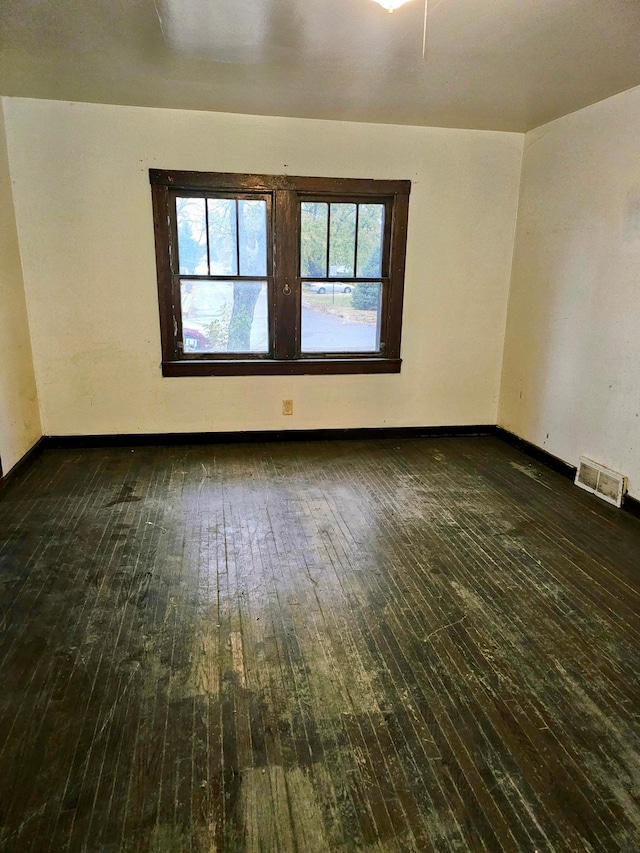 empty room with dark hardwood / wood-style flooring