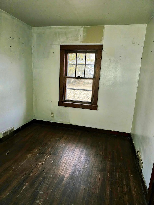 unfurnished room featuring dark hardwood / wood-style flooring