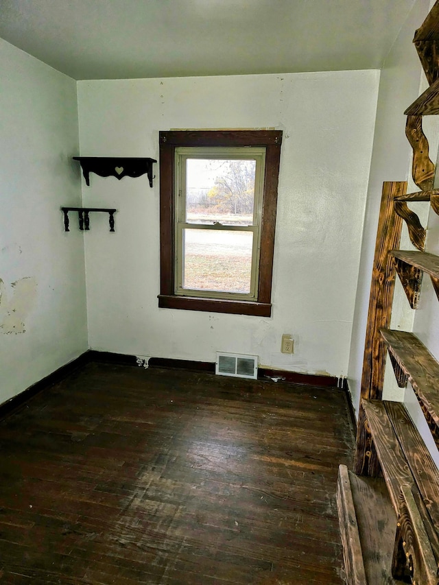 spare room with dark hardwood / wood-style flooring