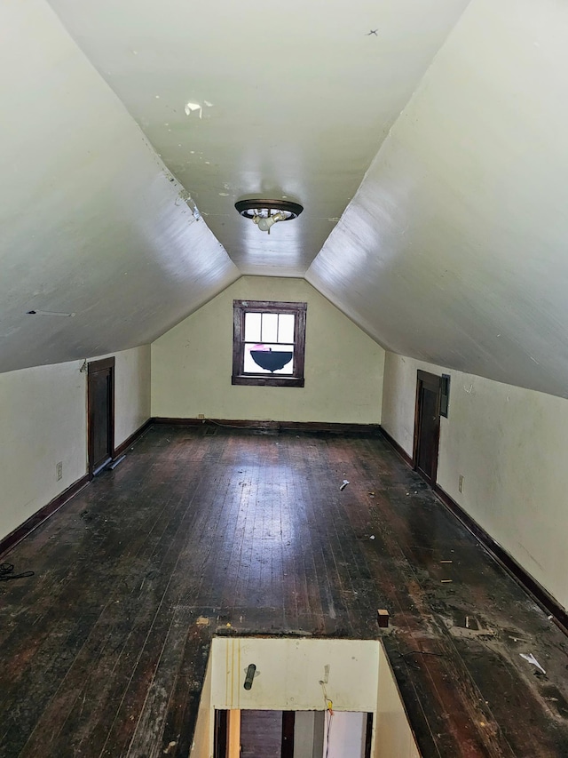 bonus room with lofted ceiling and dark hardwood / wood-style floors