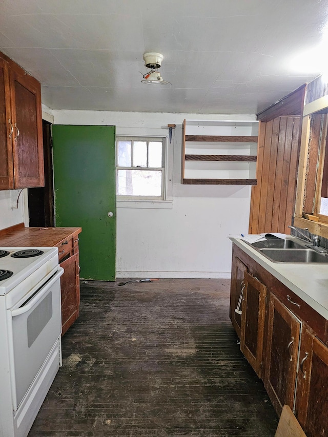 kitchen with dark wood-type flooring, sink, and white electric range oven