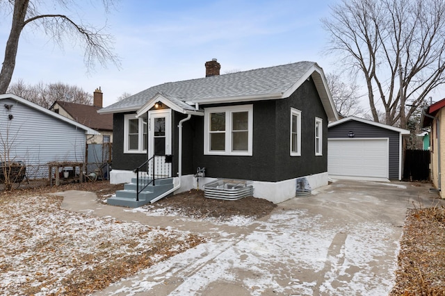 view of front of property with a garage and an outdoor structure