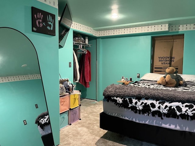 bedroom featuring light colored carpet and a closet